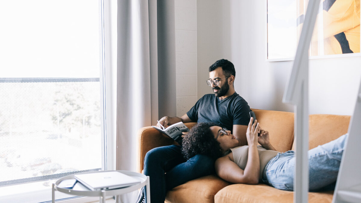 Two residents relaxing on a sofa
